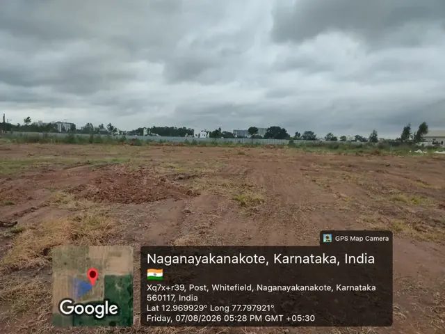 Wide view across the cleared Godrej Florenne land parcel in Naganayakanakote, off Whitefield, with residential towers on the horizon, 7 August 2026