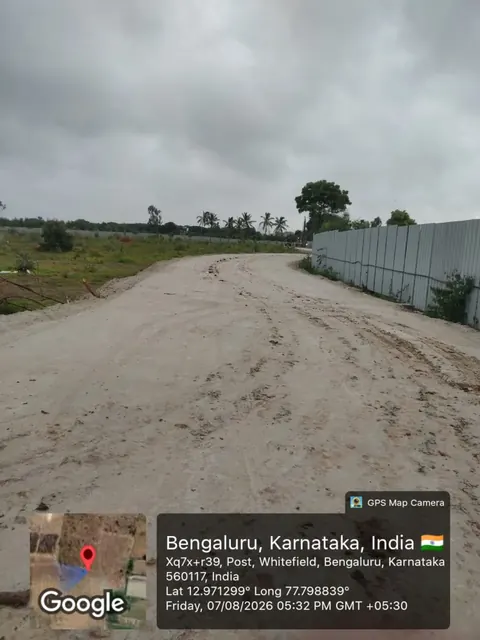 Graded access road running alongside the boundary hoarding at the Godrej Florenne site, Soukya Road, off Whitefield, 7 August 2026